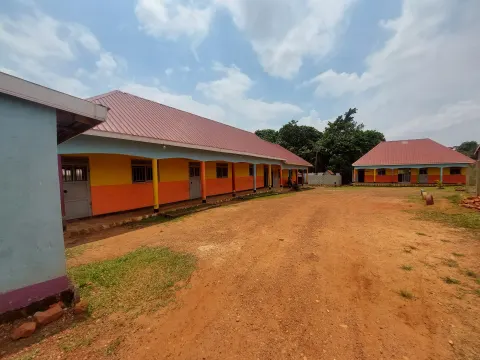 School buildings around the dirt courtyard